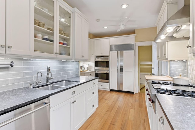 4943 Dupont Ave S, Minneapolis, MN 55419 - kitchen featuring appliances with stainless steel finishes, extractor fan, ceiling fan, white cabinets, and backsplash