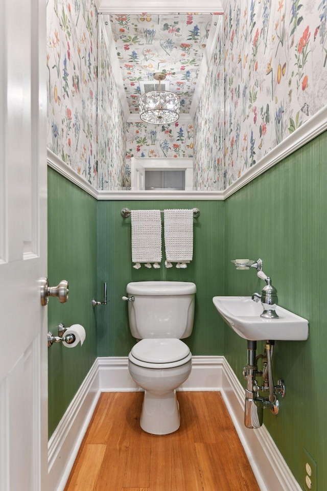4943 Dupont Ave S, Minneapolis, MN 55419 - half bath with wallpapered walls, a wainscoted wall, and wood finished floors