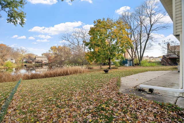 view of yard with a patio and a water view