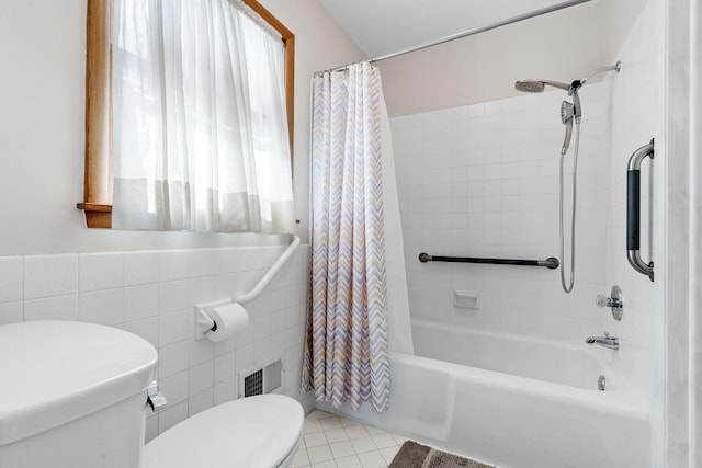 full bath with visible vents, toilet, shower / bath combo, tile walls, and tile patterned flooring