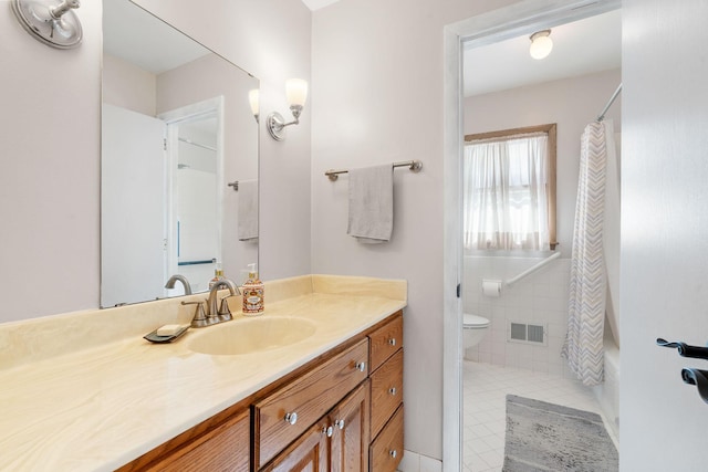 full bathroom with vanity, tile patterned floors, toilet, and visible vents