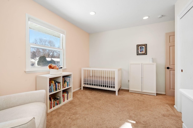 bedroom featuring carpet flooring, recessed lighting, baseboards, and a nursery area