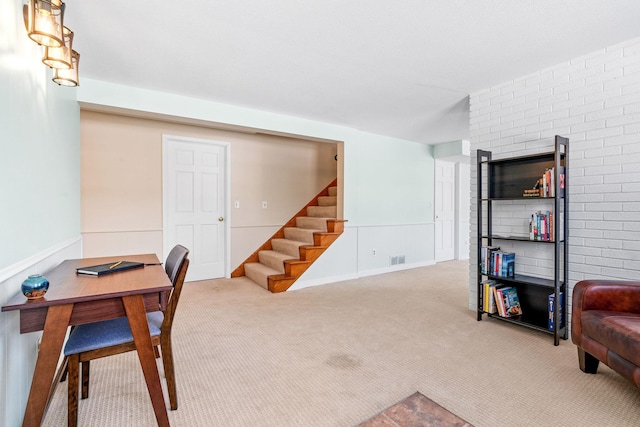 home office with carpet flooring, visible vents, and a wainscoted wall