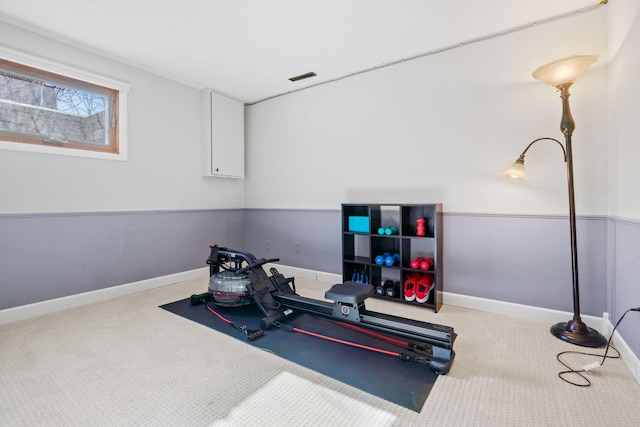 exercise area featuring baseboards, carpet floors, and visible vents