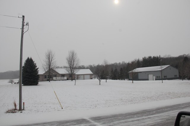 yard covered in snow with a garage