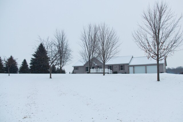 yard covered in snow with a garage