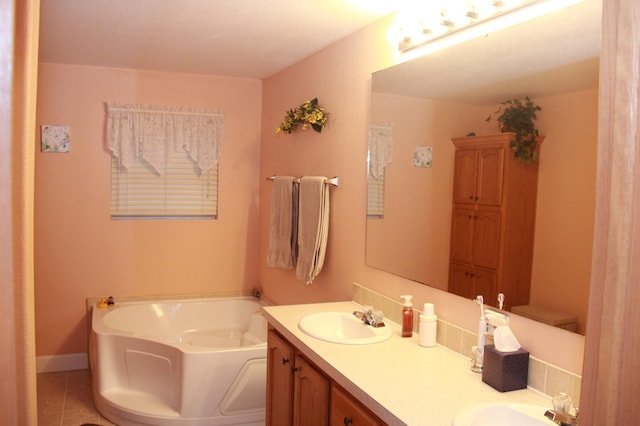 bathroom featuring double vanity, a garden tub, baseboards, and a sink