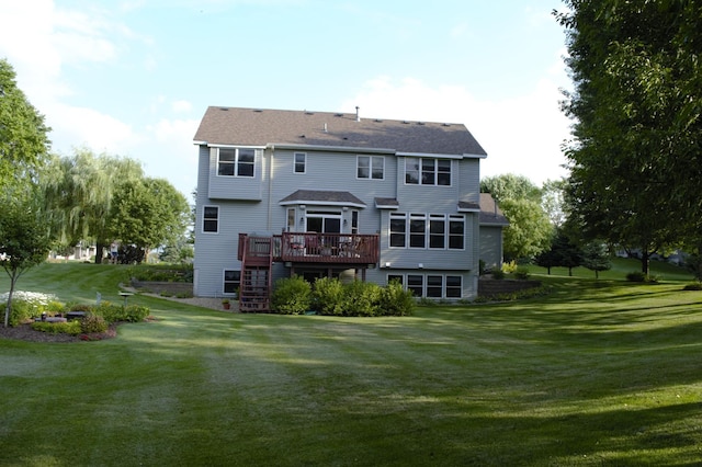 rear view of property with a yard, a wooden deck, and stairs