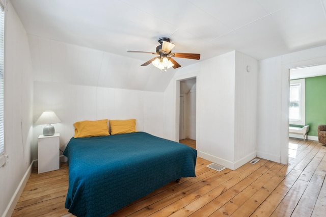 bedroom with lofted ceiling, light wood finished floors, ceiling fan, and baseboards