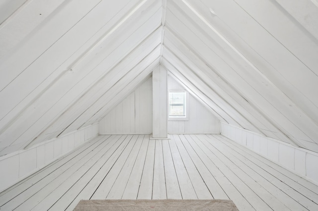 exterior space featuring a sauna, vaulted ceiling, wood finished floors, and wood walls