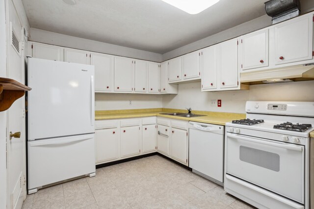 kitchen featuring light countertops, a sink, under cabinet range hood, white appliances, and white cabinetry