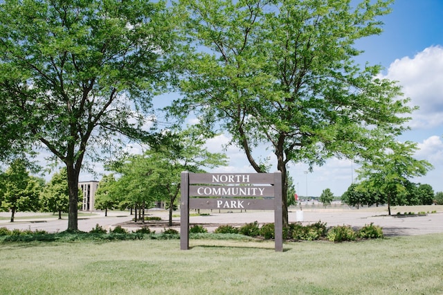 community / neighborhood sign with a lawn