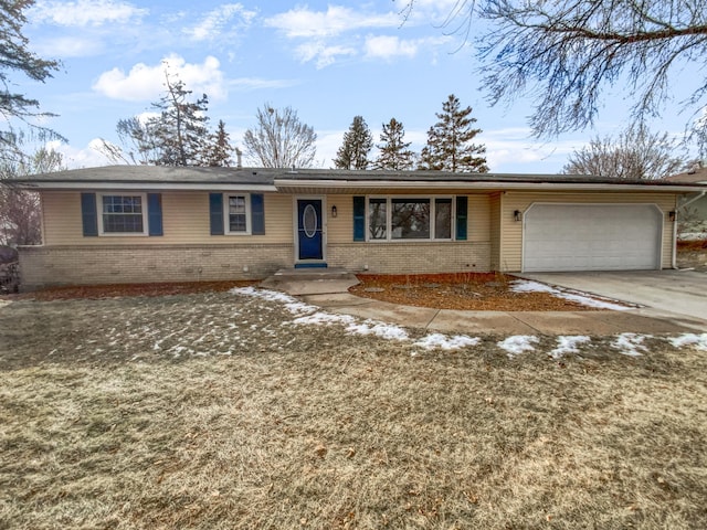 ranch-style home featuring a garage, concrete driveway, and brick siding