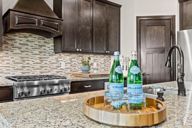 4680 Spruce Way, Medina, MN 55359 - kitchen featuring custom range hood, stove, dark brown cabinetry, and backsplash