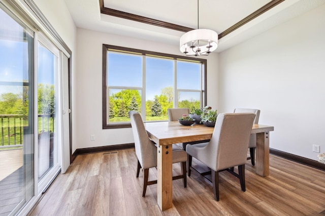 4680 Spruce Way, Medina, MN 55359 - dining room featuring a chandelier, plenty of natural light, light wood-style flooring, and a raised ceiling