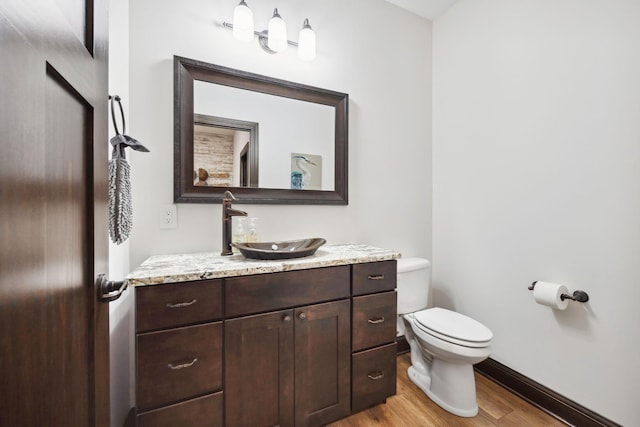 4680 Spruce Way, Medina, MN 55359 - bathroom featuring wood finished floors, toilet, baseboards, and vanity
