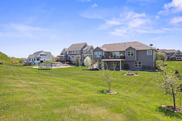 4680 Spruce Way, Medina, MN 55359 - view of grassy yard featuring an outdoor fire pit, a deck, and a residential view