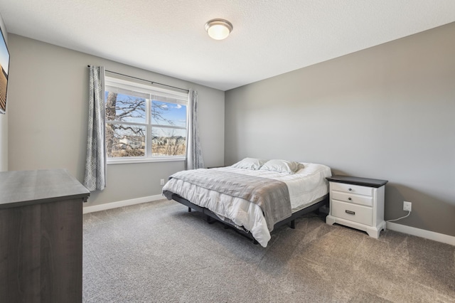 bedroom featuring a textured ceiling, carpet flooring, and baseboards