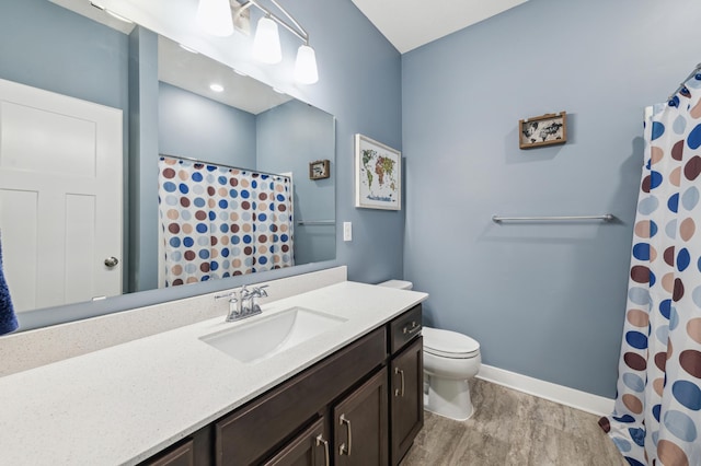 full bathroom with baseboards, toilet, a shower with curtain, wood finished floors, and vanity