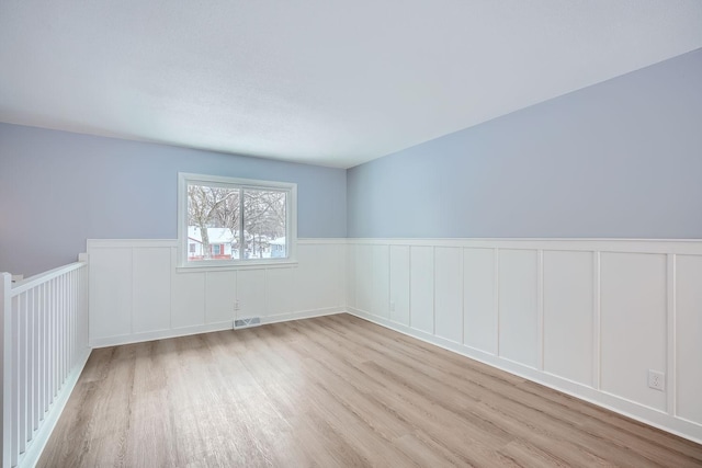 empty room with light hardwood / wood-style flooring