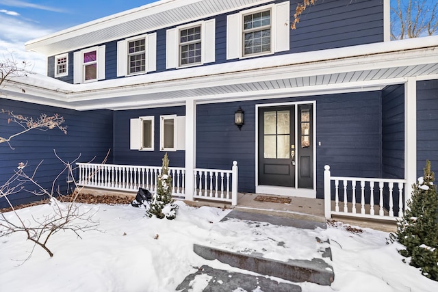 view of snow covered property entrance