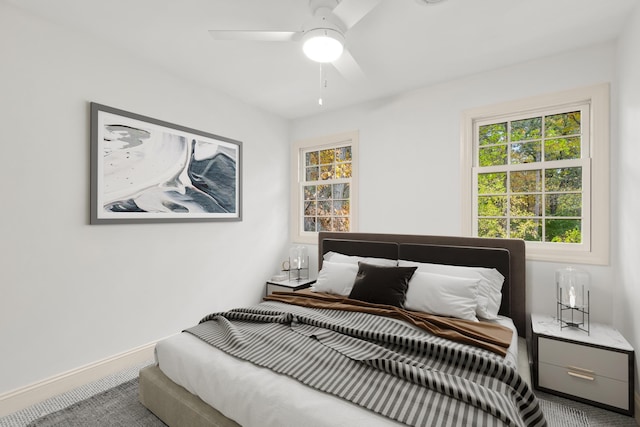 bedroom with carpet floors, a ceiling fan, and baseboards