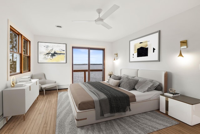 bedroom featuring light wood-style floors, access to outside, a ceiling fan, and visible vents