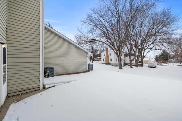 yard covered in snow featuring central AC