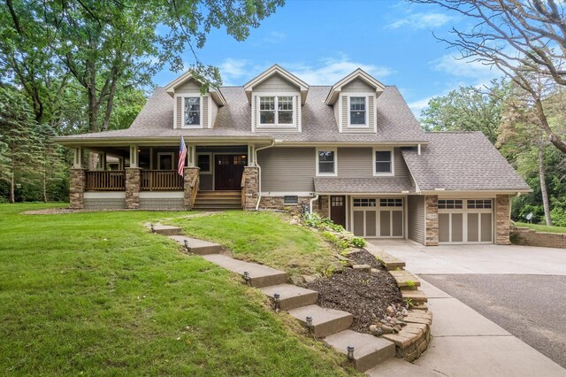 6388 Jasmine Ave N, Stillwater, MN 55082 - craftsman-style house with covered porch, stone siding, driveway, and a front lawn