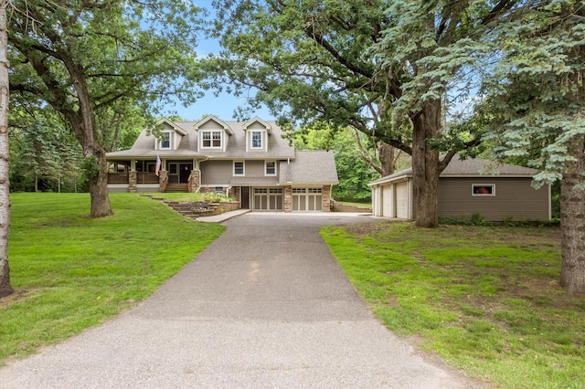 6388 Jasmine Ave N, Stillwater, MN 55082 - view of front facade with covered porch, a front lawn, asphalt driveway, and stone siding