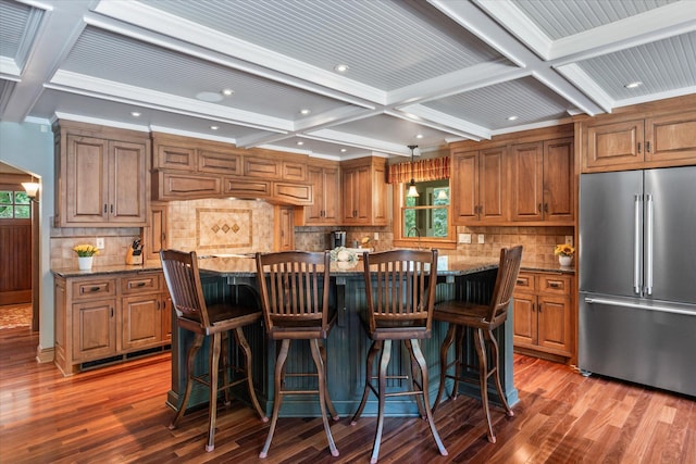6388 Jasmine Ave N, Stillwater, MN 55082 - kitchen with high end refrigerator, coffered ceiling, brown cabinets, wood finished floors, and beam ceiling