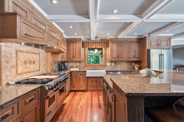 6388 Jasmine Ave N, Stillwater, MN 55082 - kitchen featuring appliances with stainless steel finishes, light wood-style flooring, beamed ceiling, light stone counters, and recessed lighting
