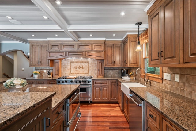 6388 Jasmine Ave N, Stillwater, MN 55082 - kitchen featuring stainless steel appliances, stone countertops, wood finished floors, brown cabinetry, and beamed ceiling