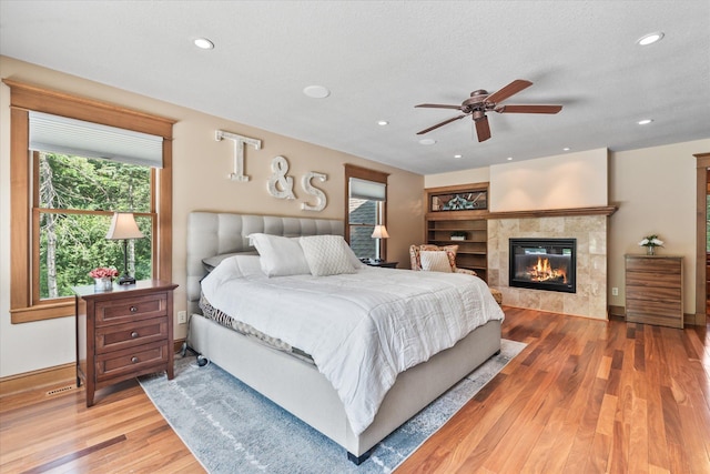 6388 Jasmine Ave N, Stillwater, MN 55082 - bedroom featuring wood finished floors, a fireplace, and recessed lighting