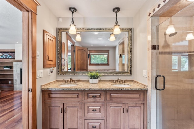 6388 Jasmine Ave N, Stillwater, MN 55082 - full bath featuring double vanity, a shower stall, wood finished floors, and a fireplace