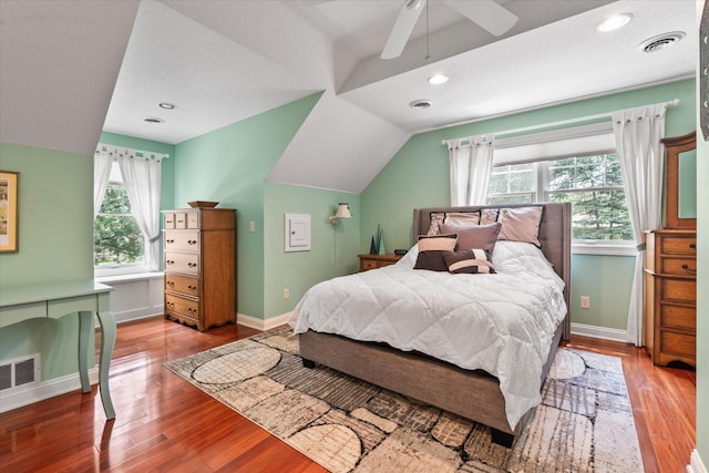 6388 Jasmine Ave N, Stillwater, MN 55082 - bedroom with multiple windows, wood finished floors, vaulted ceiling, and ceiling fan