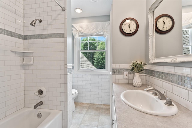 6388 Jasmine Ave N, Stillwater, MN 55082 - bathroom featuring vanity, tile walls, washtub / shower combination, tile patterned floors, and a wainscoted wall