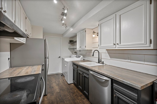 kitchen featuring under cabinet range hood, stainless steel appliances, separate washer and dryer, a sink, and white cabinetry