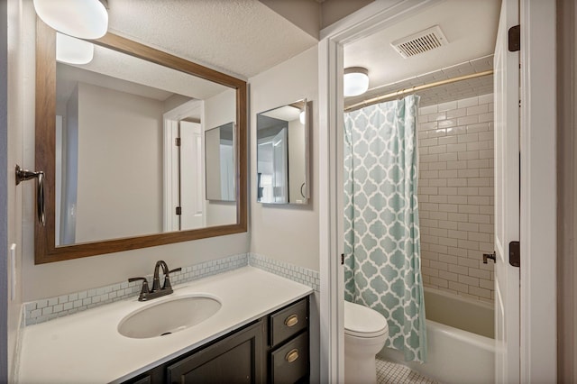 bathroom featuring visible vents, toilet, shower / bath combo, vanity, and a textured ceiling