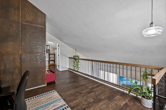 office space featuring dark wood-style floors, a textured ceiling, and lofted ceiling