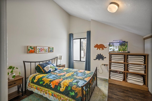 bedroom with dark wood-type flooring, vaulted ceiling, a textured ceiling, and baseboards