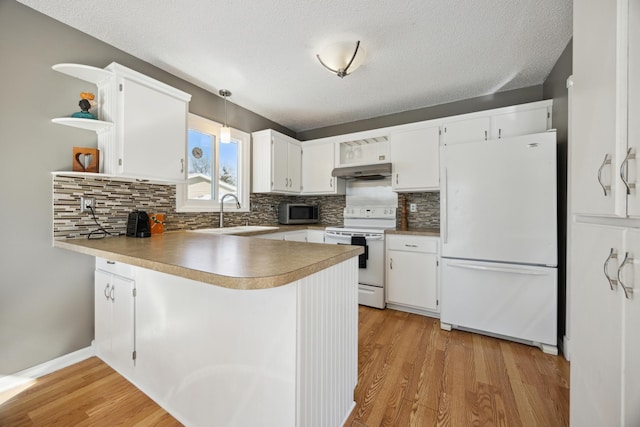 kitchen featuring white appliances, white cabinetry, pendant lighting, and kitchen peninsula