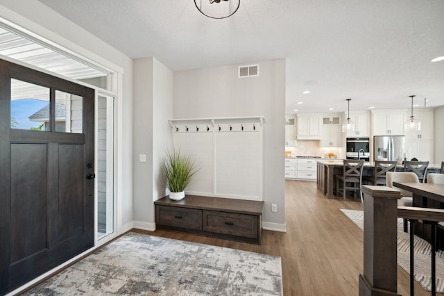 entryway with hardwood / wood-style floors