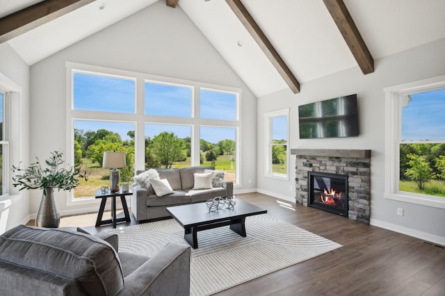 living room featuring plenty of natural light, dark wood-type flooring, high vaulted ceiling, a fireplace, and beamed ceiling