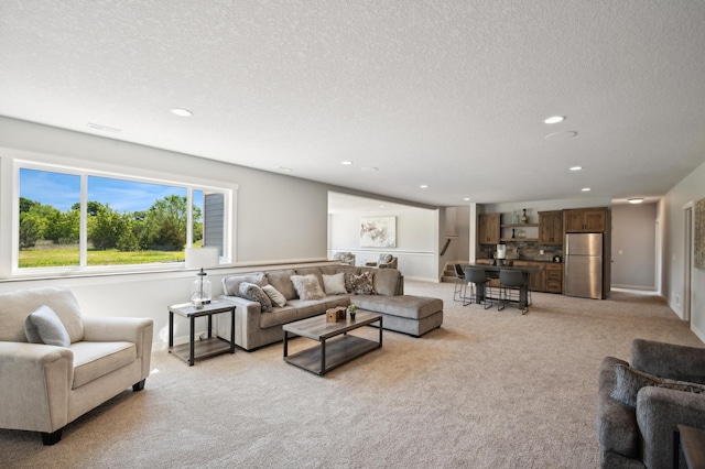 living room with light carpet and a textured ceiling