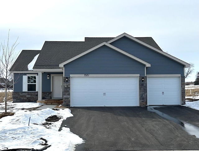 ranch-style home featuring a garage, stone siding, driveway, and roof with shingles