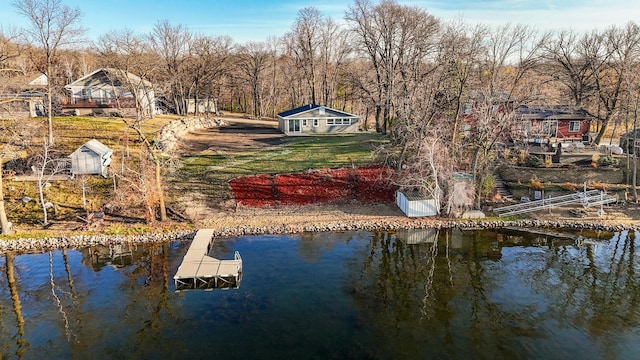 dock area featuring a water view and a yard