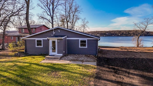 view of front of property featuring a water view and a front lawn