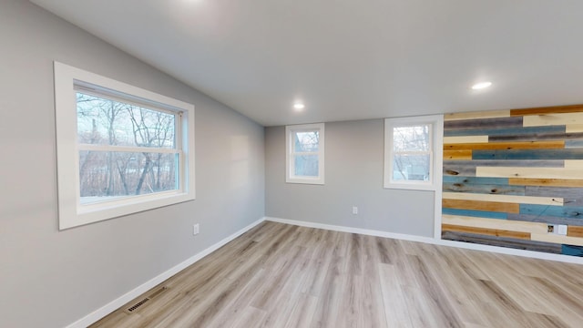 empty room featuring baseboards, visible vents, wood finished floors, and recessed lighting