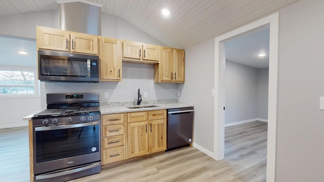 kitchen featuring lofted ceiling, light wood-style flooring, stainless steel appliances, light brown cabinetry, and a sink